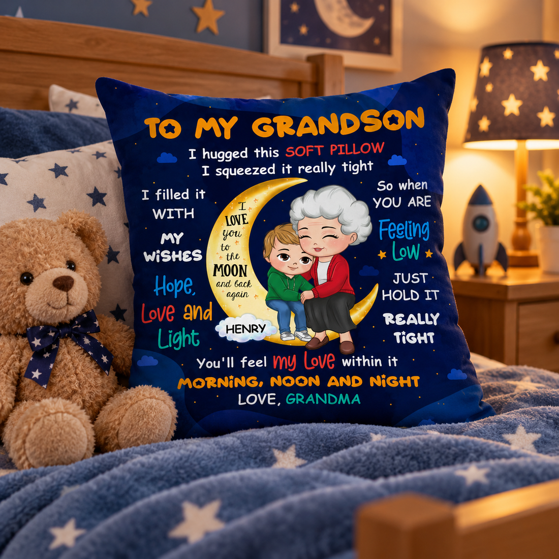 Personalized To My Grandson moon pillow on a boy's bed beside a teddy bear
