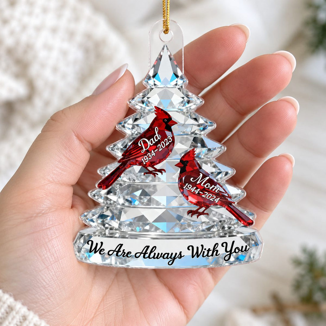 Adult woman's hand holding a Memorial Tree Cardinals Christmas personalized acrylic ornament.