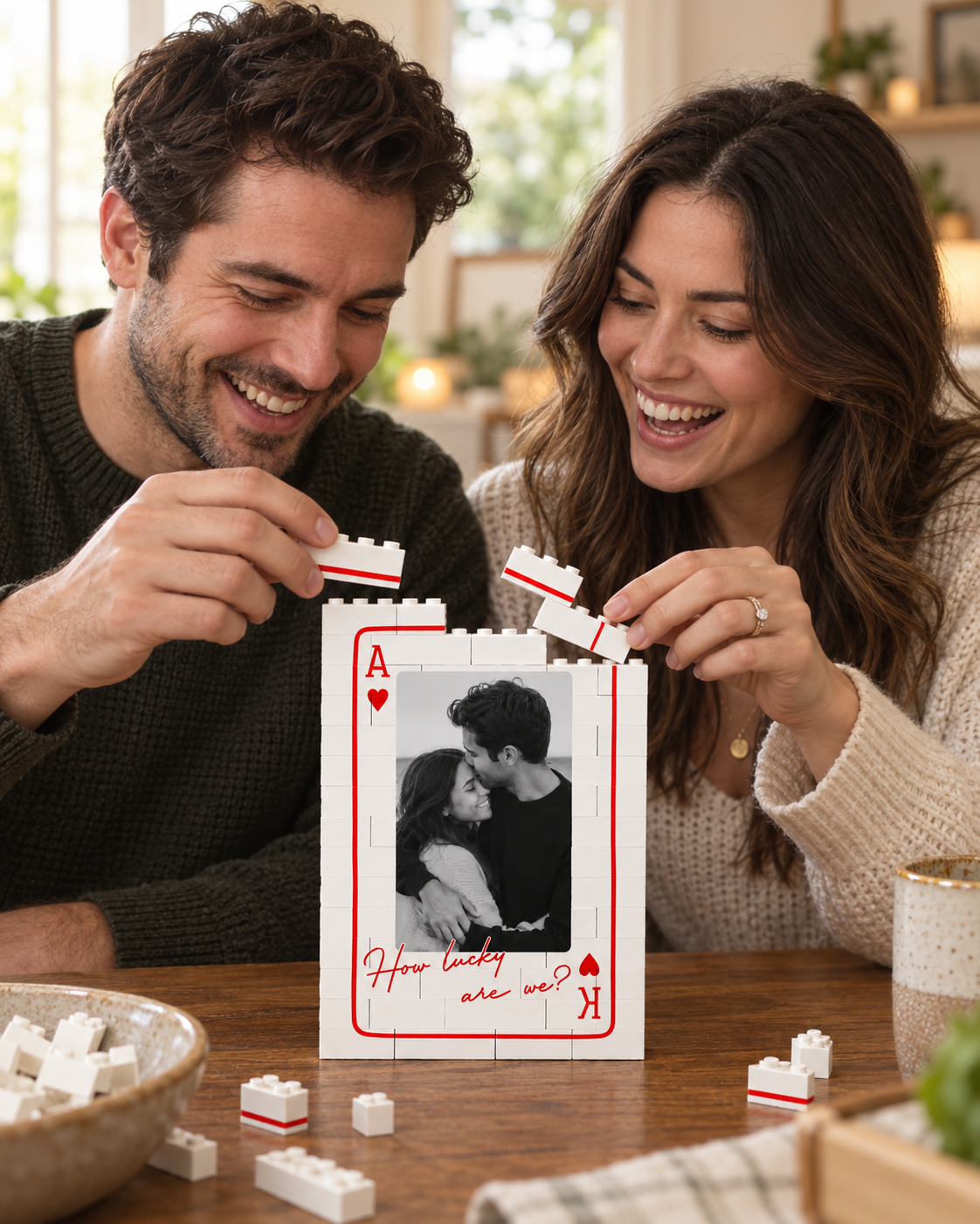 Couple building a personalized brick card frame together at a table
