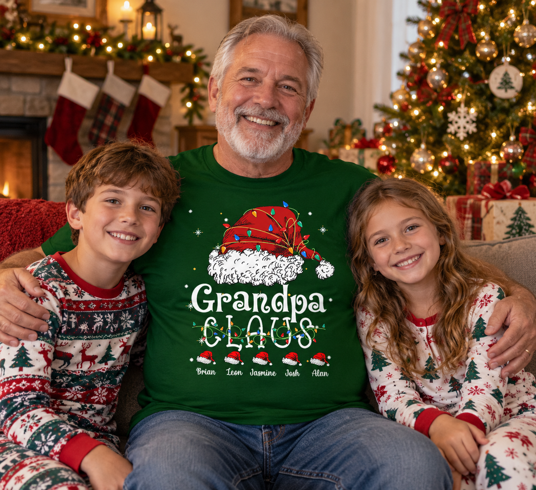 Grandpa in a Christmas Claus t-shirt by the tree with two grandkids