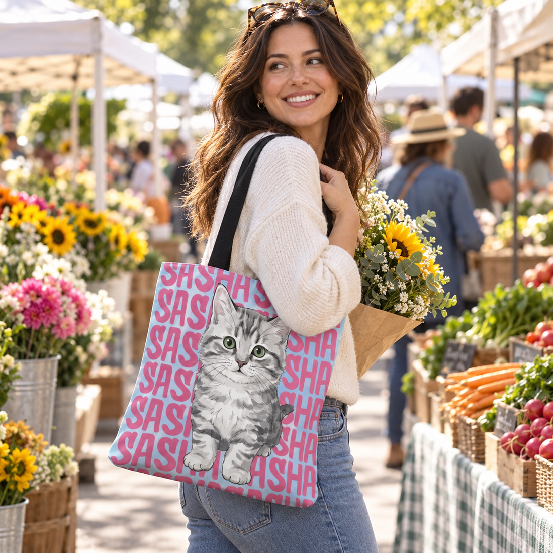 Woman carrying a personalized pet portrait tote bag at a farmers market