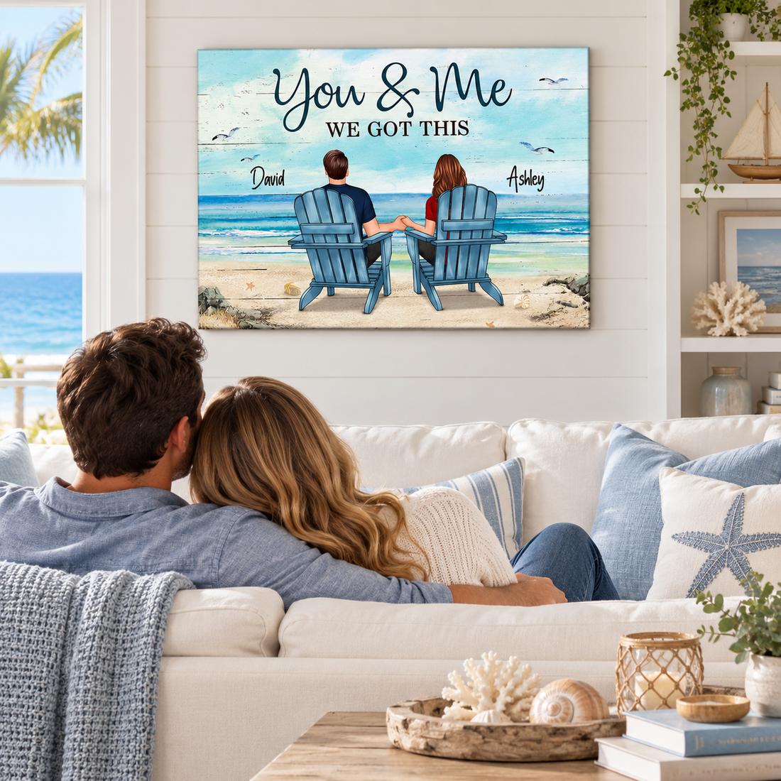 Custom back view couple beach poster above a coastal living room sofa with seashells