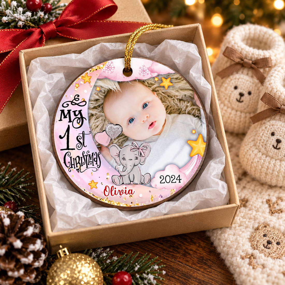 Custom Baby's First Christmas wood ornament in a gift box with ribbon beside baby booties
