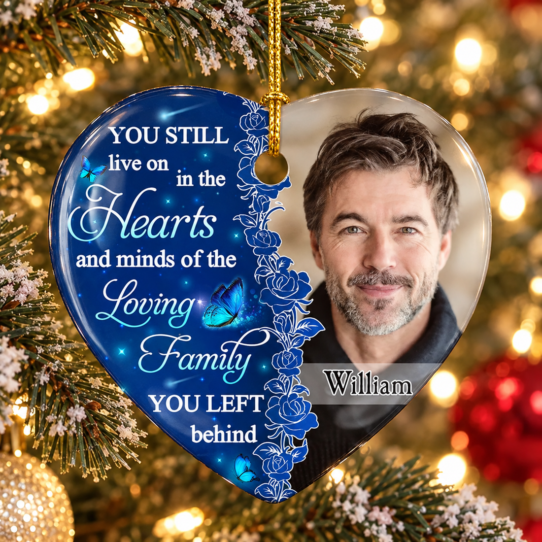 Personalized blue heart memorial ceramic ornament with a man's photo and name William on a Christmas tree
