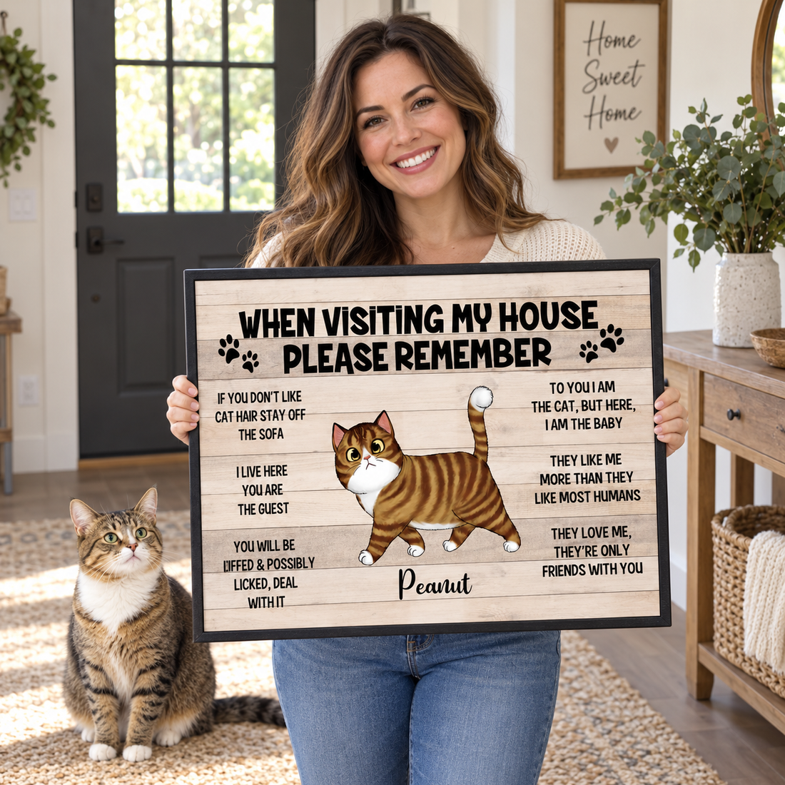 Woman holding a personalized When Visiting My House Please Remember cat canvas print at home
