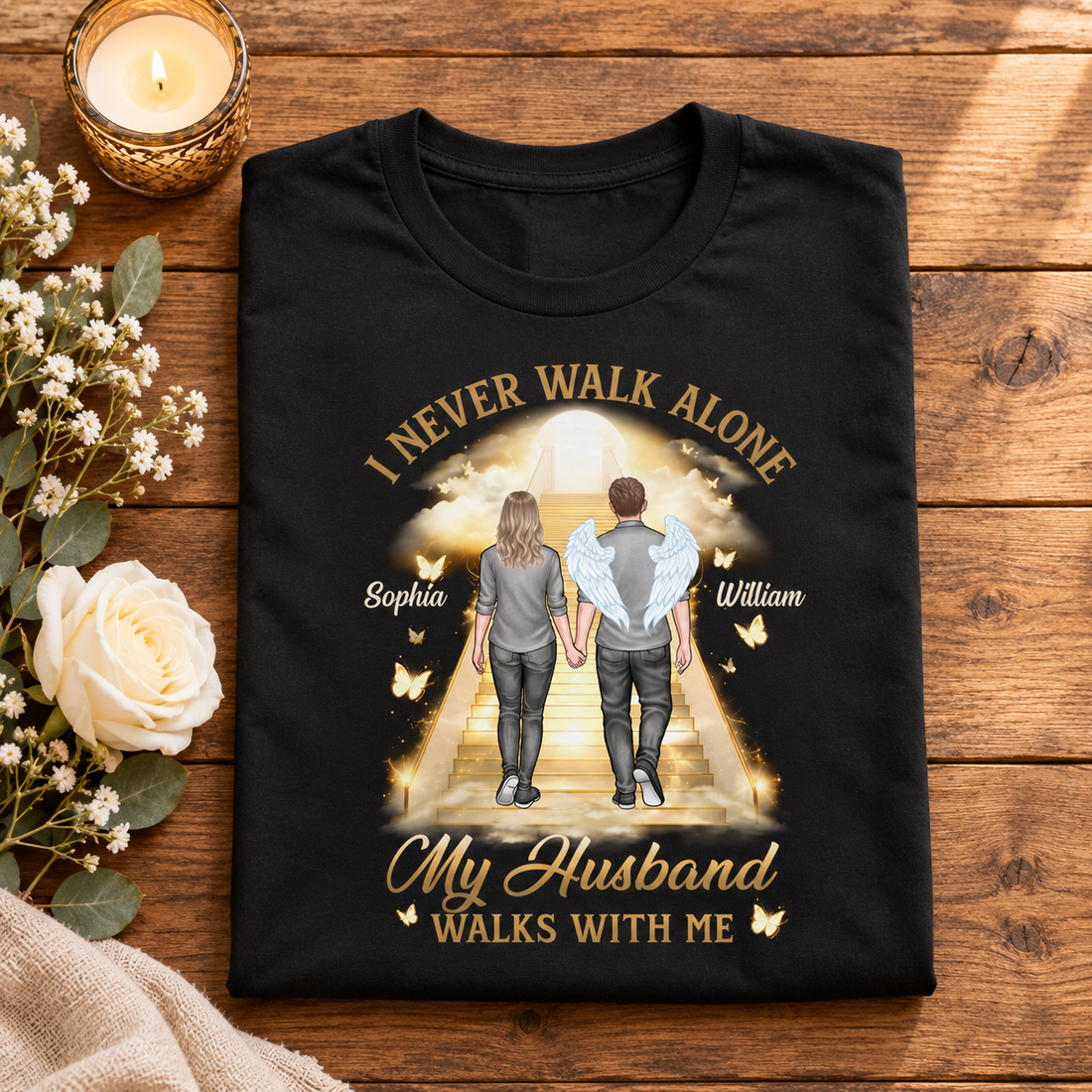 Personalized memorial t-shirt folded on a wooden table with a candle and flowers