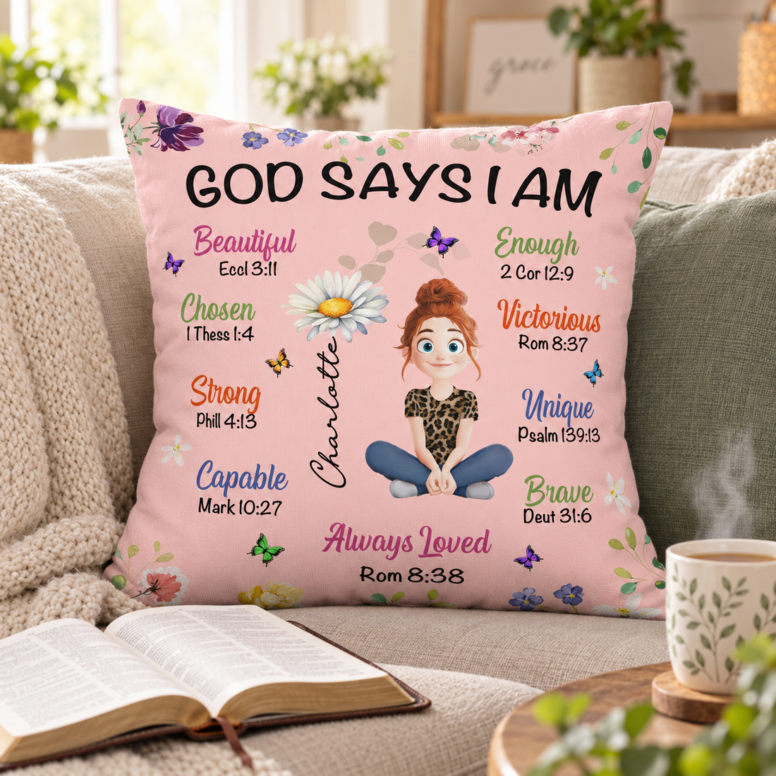 Personalized birth flower Christian pillow on a cozy sofa next to an open Bible and tea
