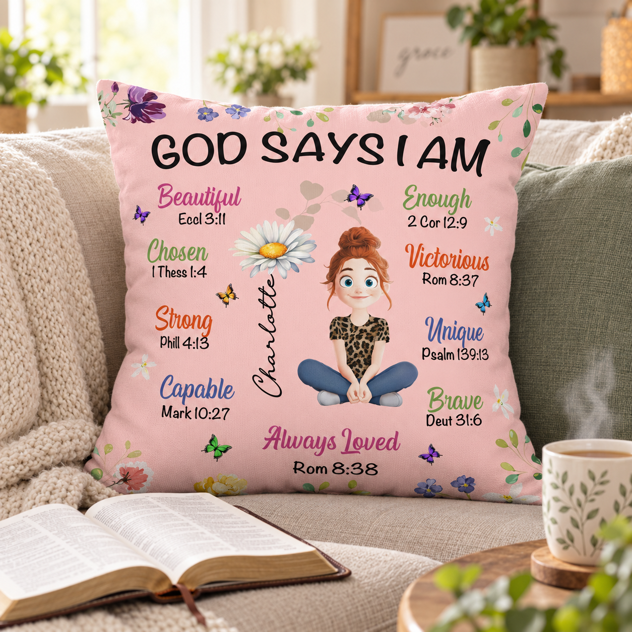 Personalized birth flower Christian pillow on a cozy sofa next to an open Bible and tea