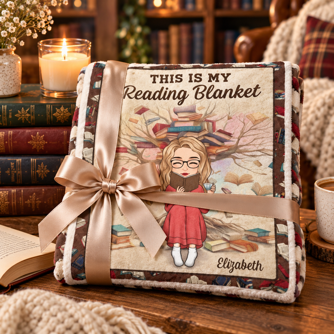Personalized reading blanket folded with a ribbon beside a stack of books and a candle, gift for bookworms