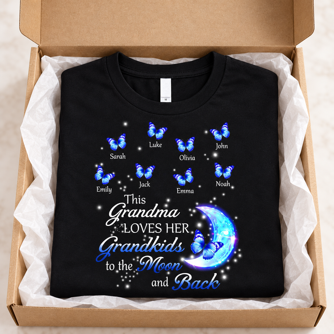Black This Grandma Loves Her Grandkids to the Moon and Back butterfly t-shirt folded in a kraft gift box