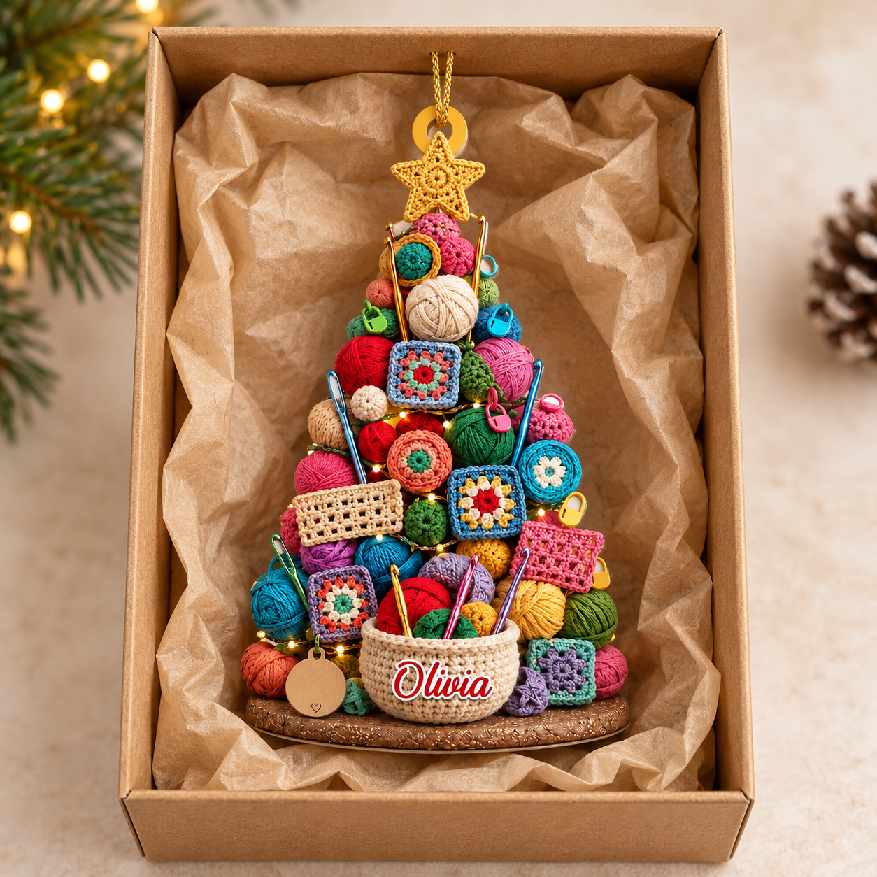 Custom crochet yarn Christmas tree ornament with name Olivia in a kraft gift box with crinkle paper
