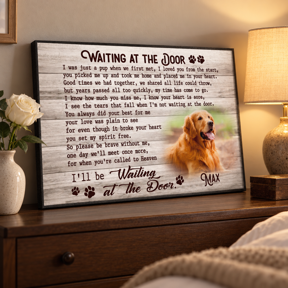 Framed pet memorial photo poster with golden retriever and name Max on a dresser beside a white rose
