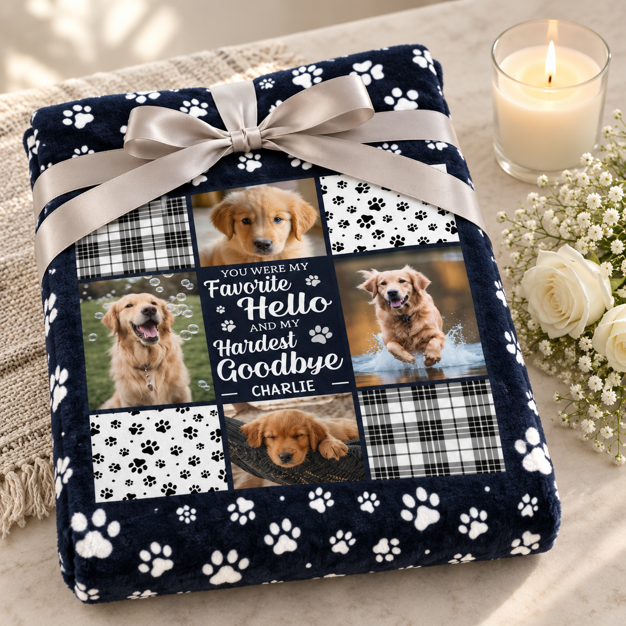 Folded pet memorial blanket as a sympathy gift with ribbon, white flowers and a candle