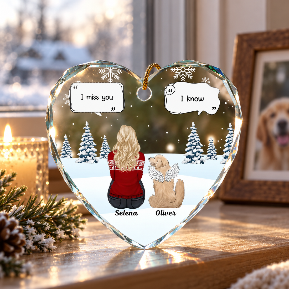 Memorial dog heart-shaped glass ornament on a windowsill beside a candle