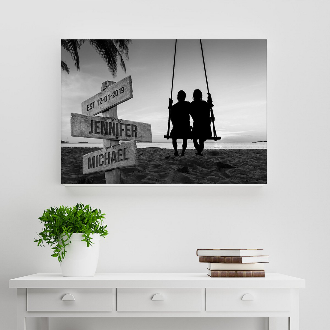 Personalized Couple Swing Names canvas print, a woman hanging the framed print on a wall