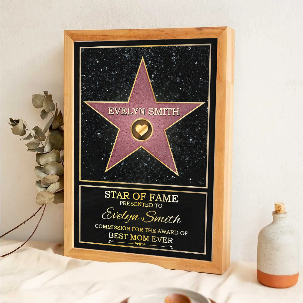 Personalized Mom or Grandma's Custom Star of Fame Canvas Print, a woman hanging the framed print on a wall