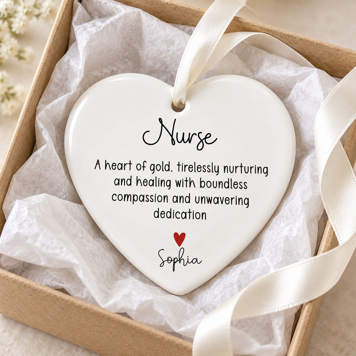 Nurse heart of gold personalized ceramic ornament nestled in a gift box with tissue paper