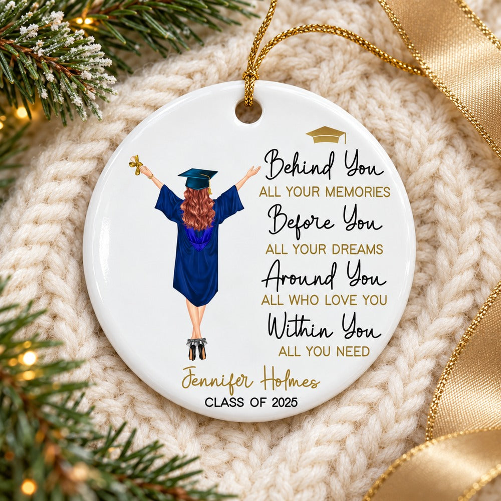 Behind You All Your Memories graduation ceramic ornament flat on a cozy cream knit blanket