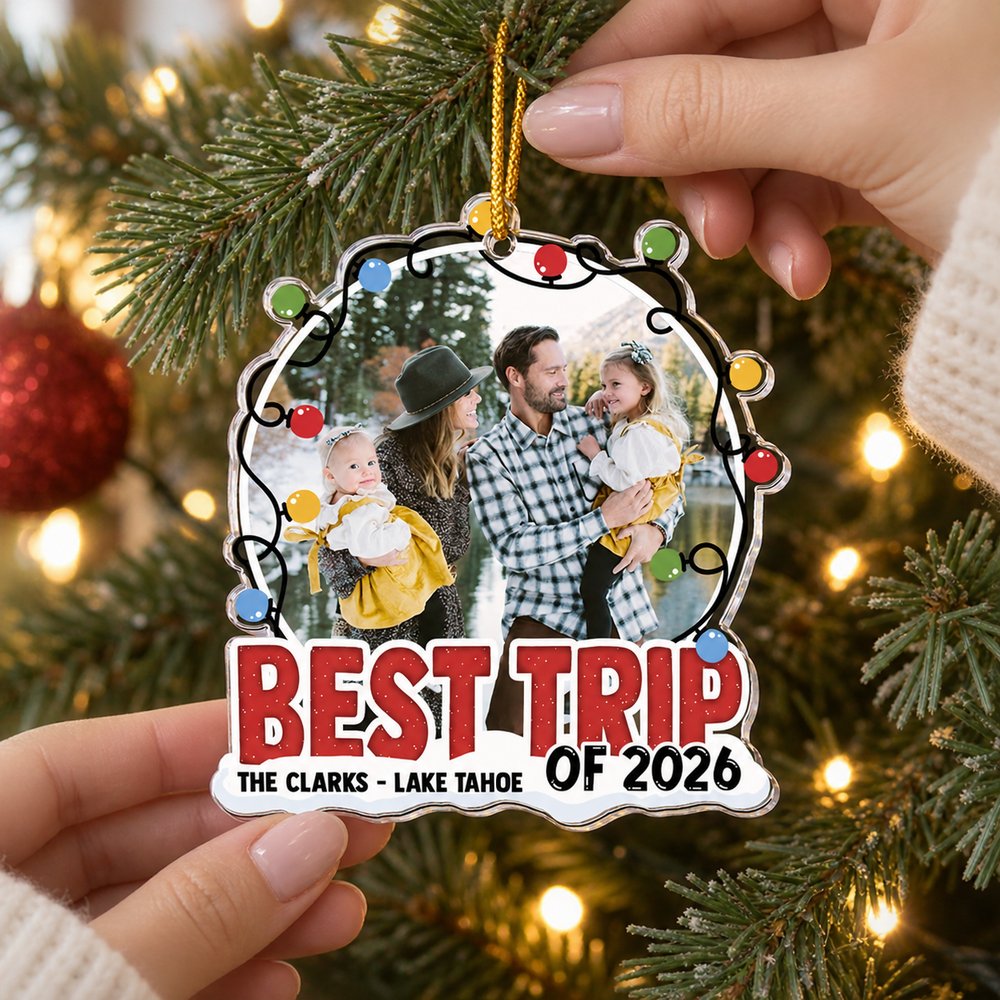 Woman hanging the Best Trip Of 2026 custom shaped acrylic family photo ornament on a Christmas tree