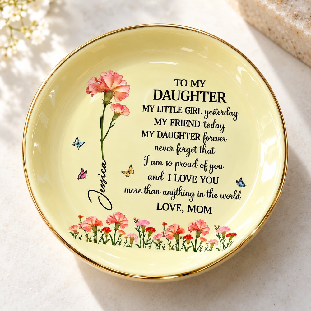 Close-up of glossy glaze, gold rim, and birth flower print on personalized daughter jewelry dish