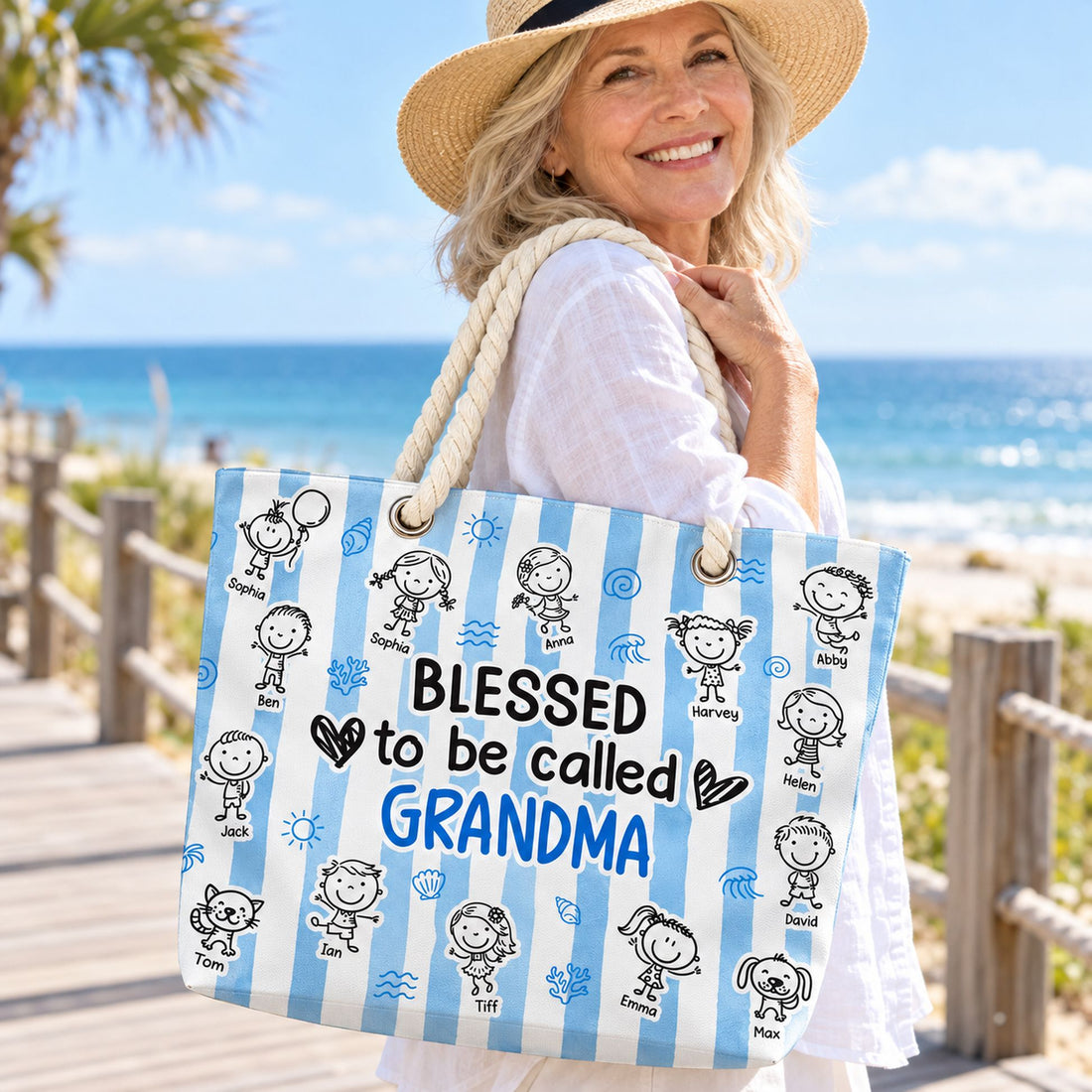 Grandma holding her Blessed To Be Called Grandma personalized striped beach bag on a sunny boardwalk
