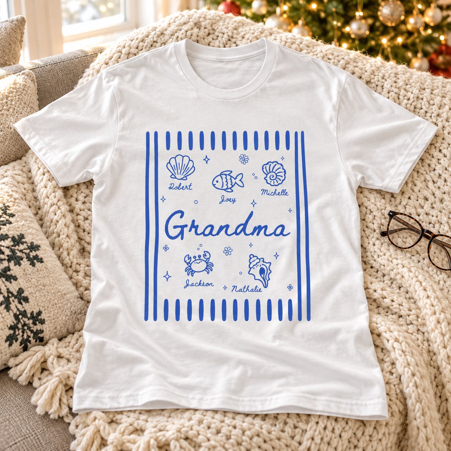Personalized Grandma summer shirt laid on a cozy sofa with holiday tree in soft background