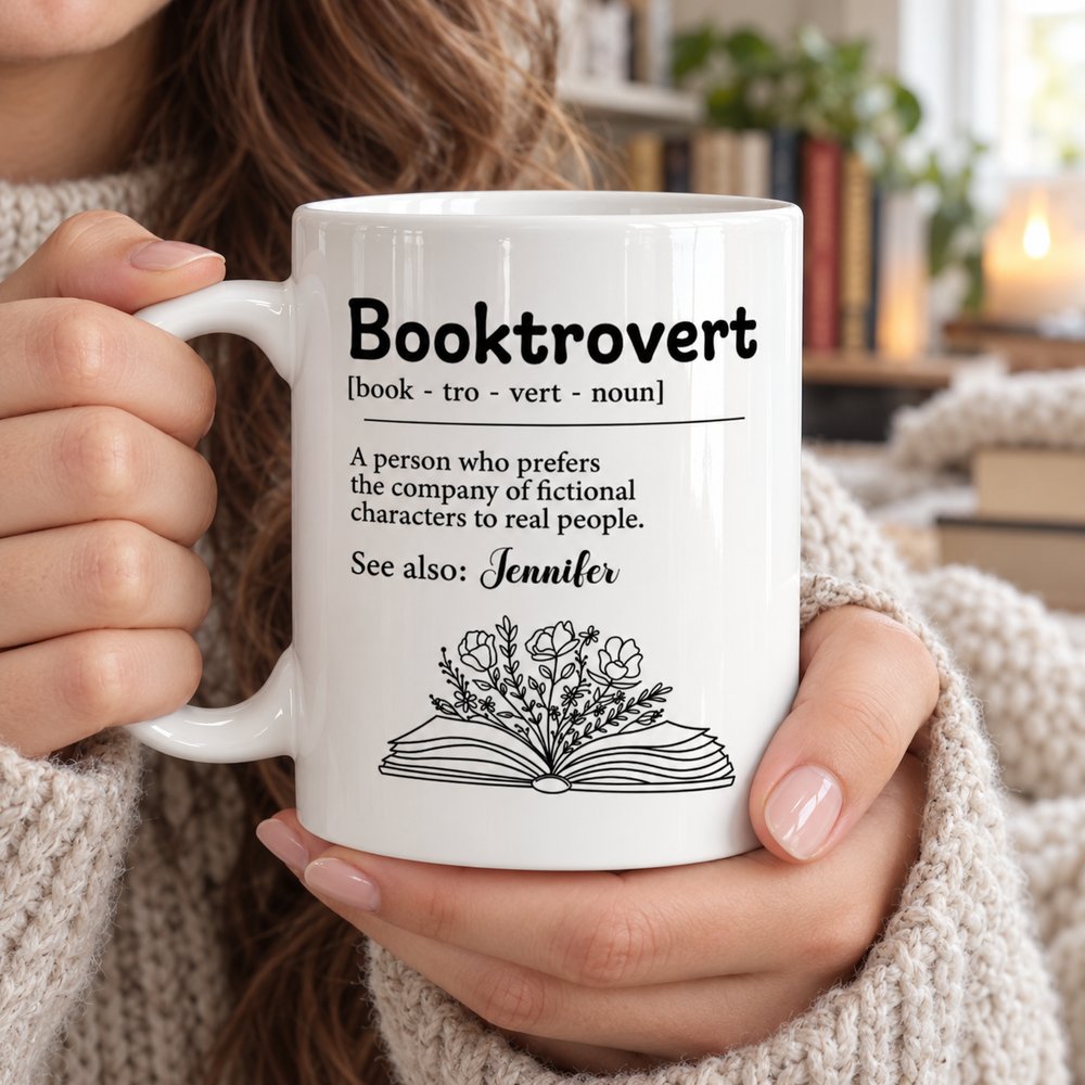 Close-up detail of Booktrovert definition and floral book line-art printed on glossy white ceramic mug