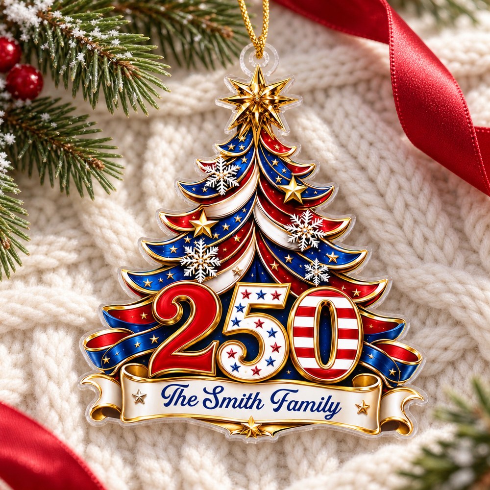 Celebrating Freedom Together custom acrylic ornament lying flat on a cozy cream knit throw with pine sprigs