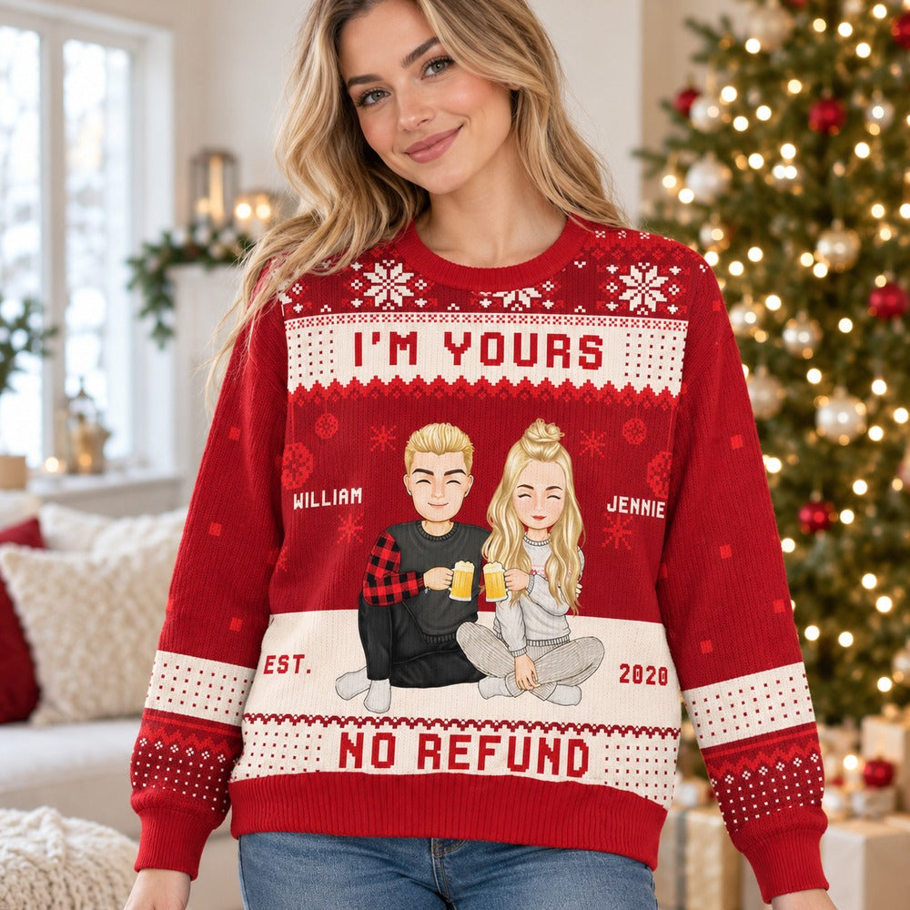 Woman wearing personalized I'm Yours No Refund Christmas ugly sweater in front of a holiday tree