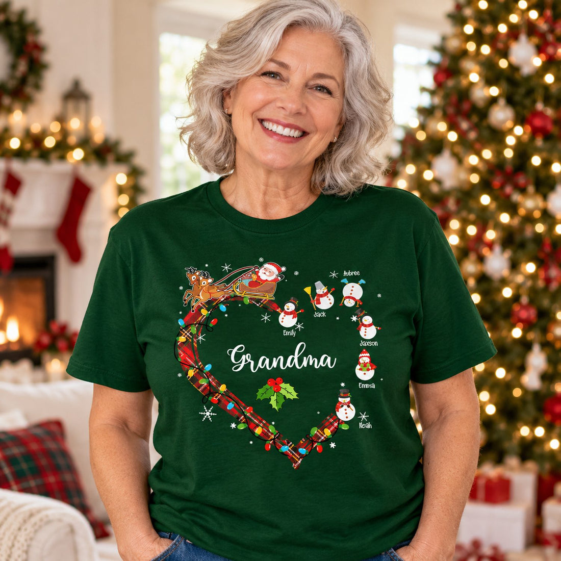 Grandma wearing forest green personalized Christmas snowman heart t-shirt by holiday tree