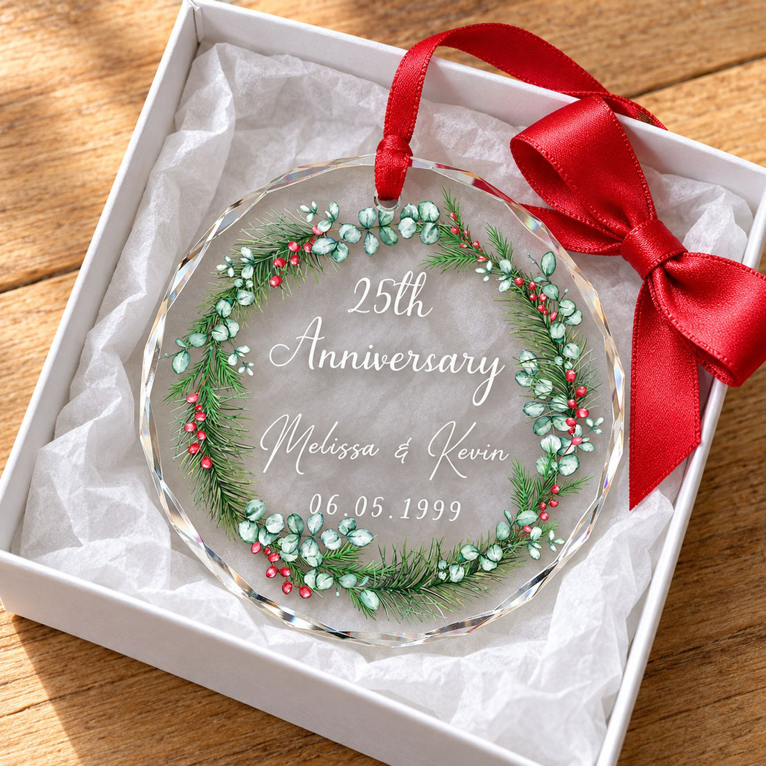Couple anniversary glass ornament nestled in a white gift box with tissue paper