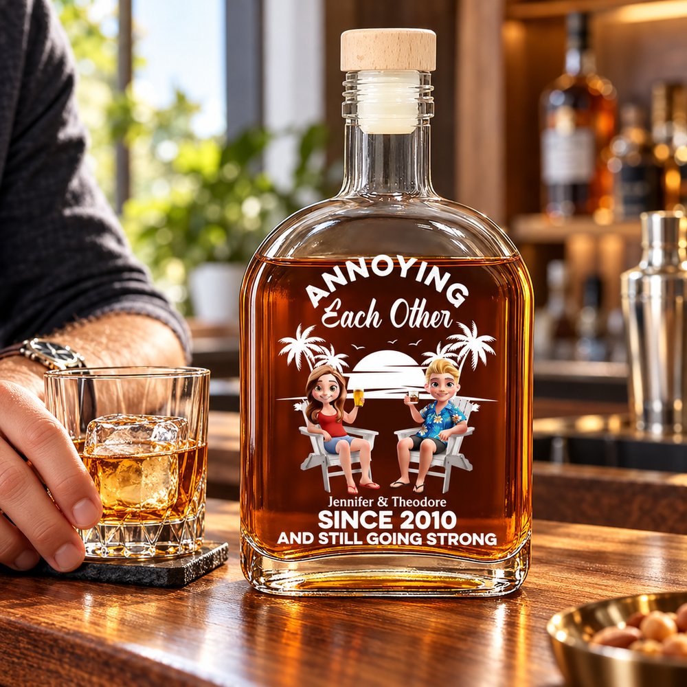 Personalized Couple Annoying Each Other whiskey bottle on a bright home bar next to a whiskey glass