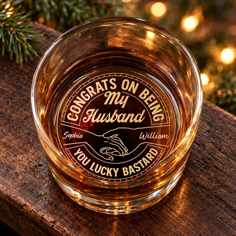 Personalized engraved whiskey glass for husband on a holiday mantel with amber liquid showing bottom engraving