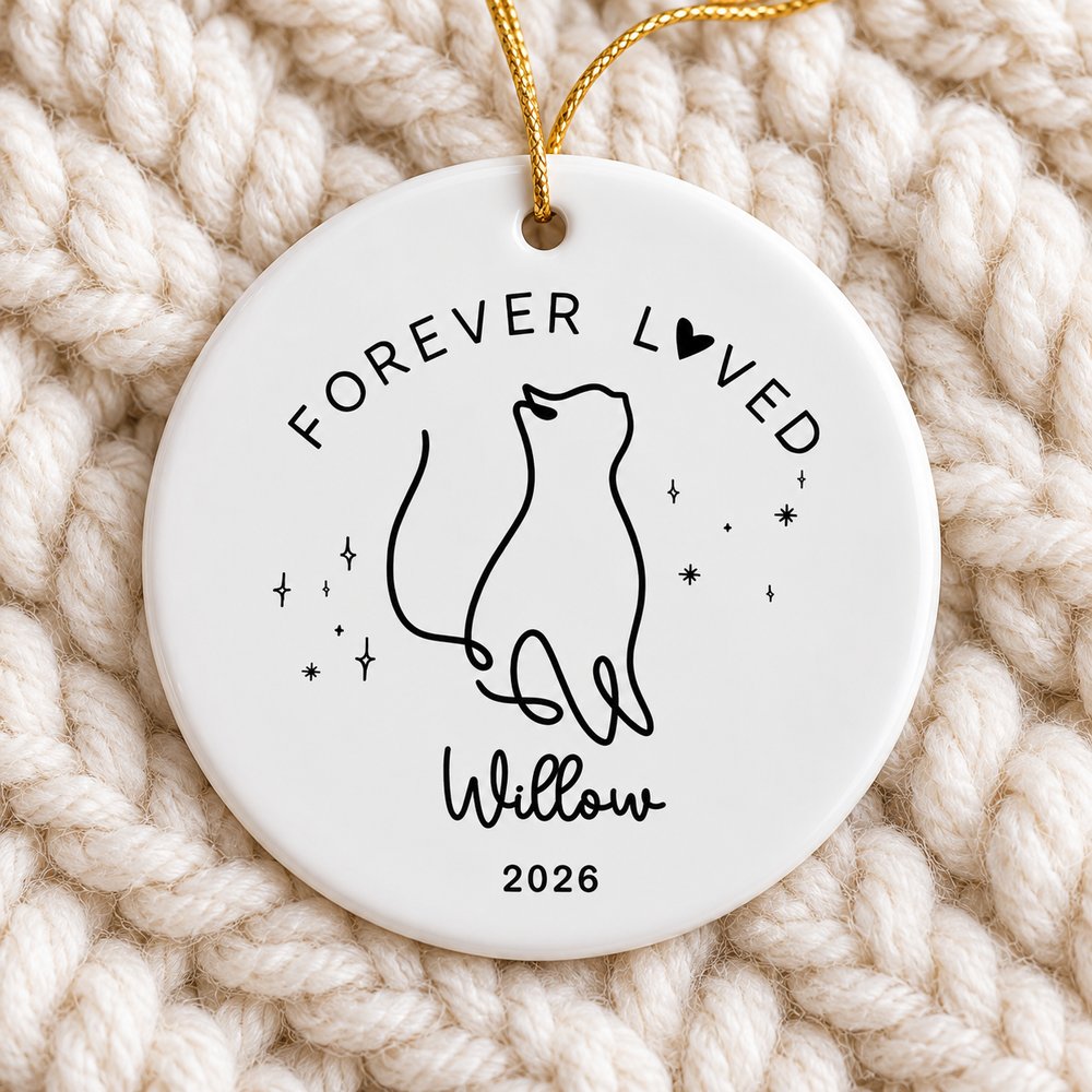 Close up of personalized cat memorial circle ceramic ornament showing glossy finish and black line art