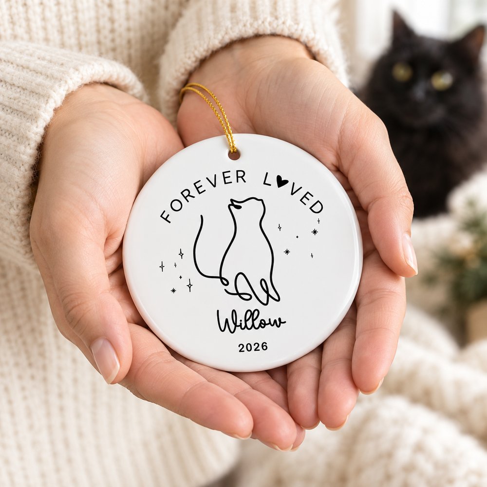 Hands holding 3 inch custom name cat memorial ceramic ornament to show real size