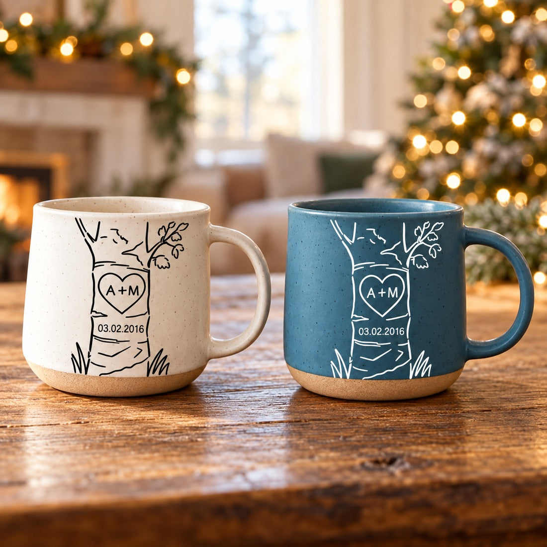 Personalized A+M anniversary pottery mugs on wooden table with festive holiday greenery