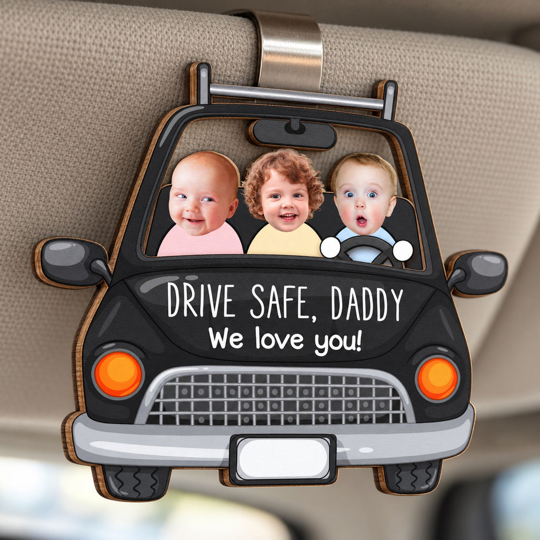 Close-up detail of 2-layer wooden Drive Safe Daddy car visor clip showing wood edges and print