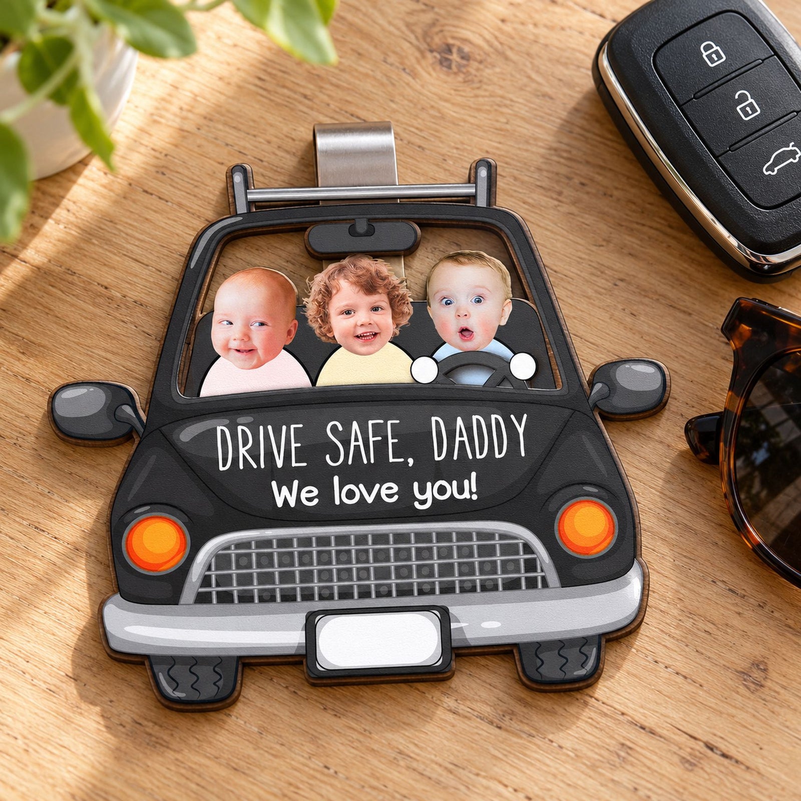 Personalized Drive Safe Daddy wooden car visor clip next to a car key fob showing true size