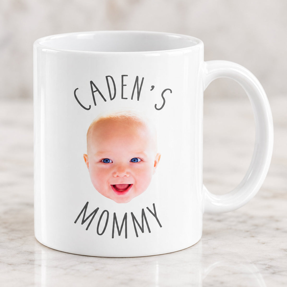 Close-up detail of glossy ceramic mug print with custom baby face and arched text