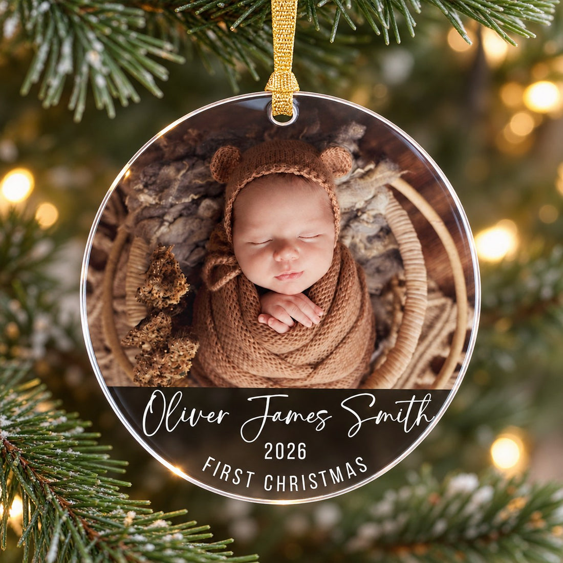 Macro close-up of custom baby first Christmas acrylic ornament showing glossy print and edge