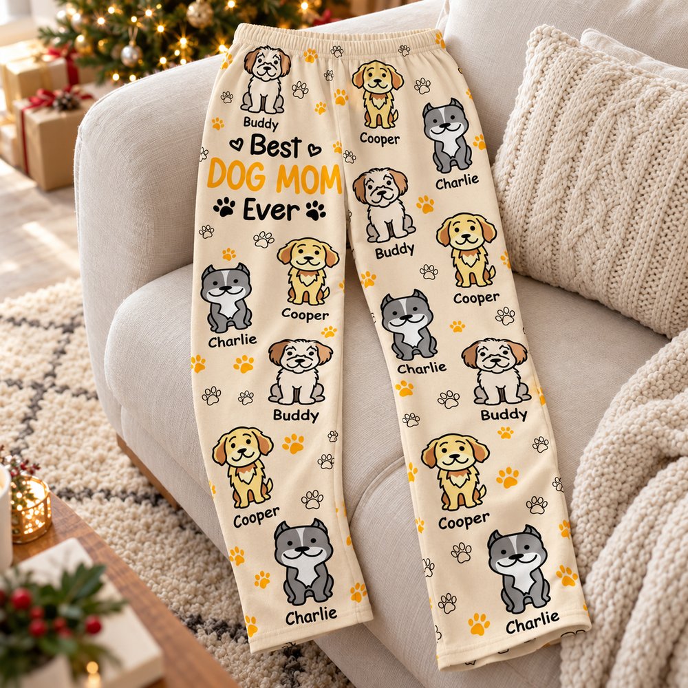 Personalized Best Dog Mom Ever pajama pants laid on a cozy holiday sofa near a Christmas tree