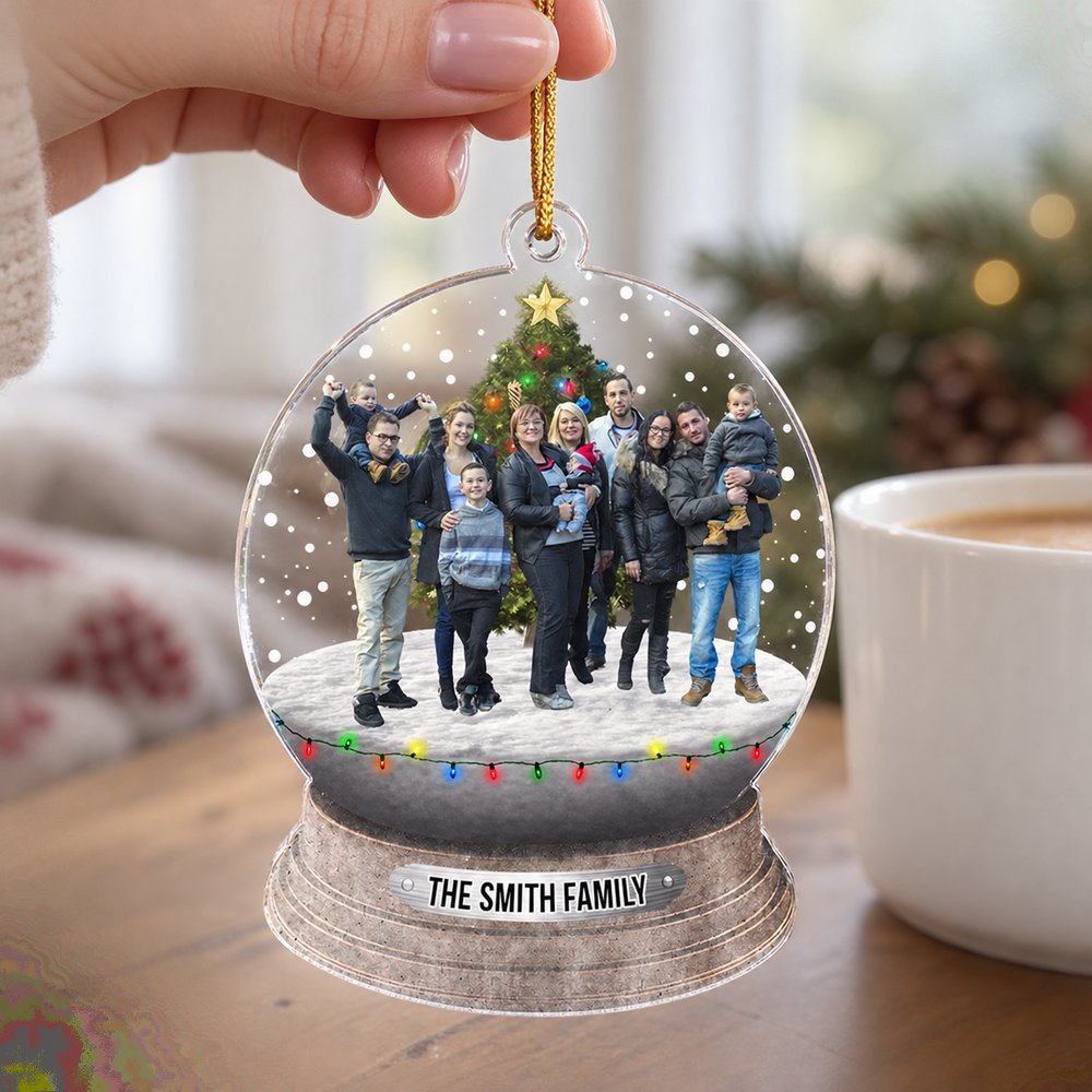 Hand holding 3.5 inch custom family photo acrylic ornament next to a mug for size comparison