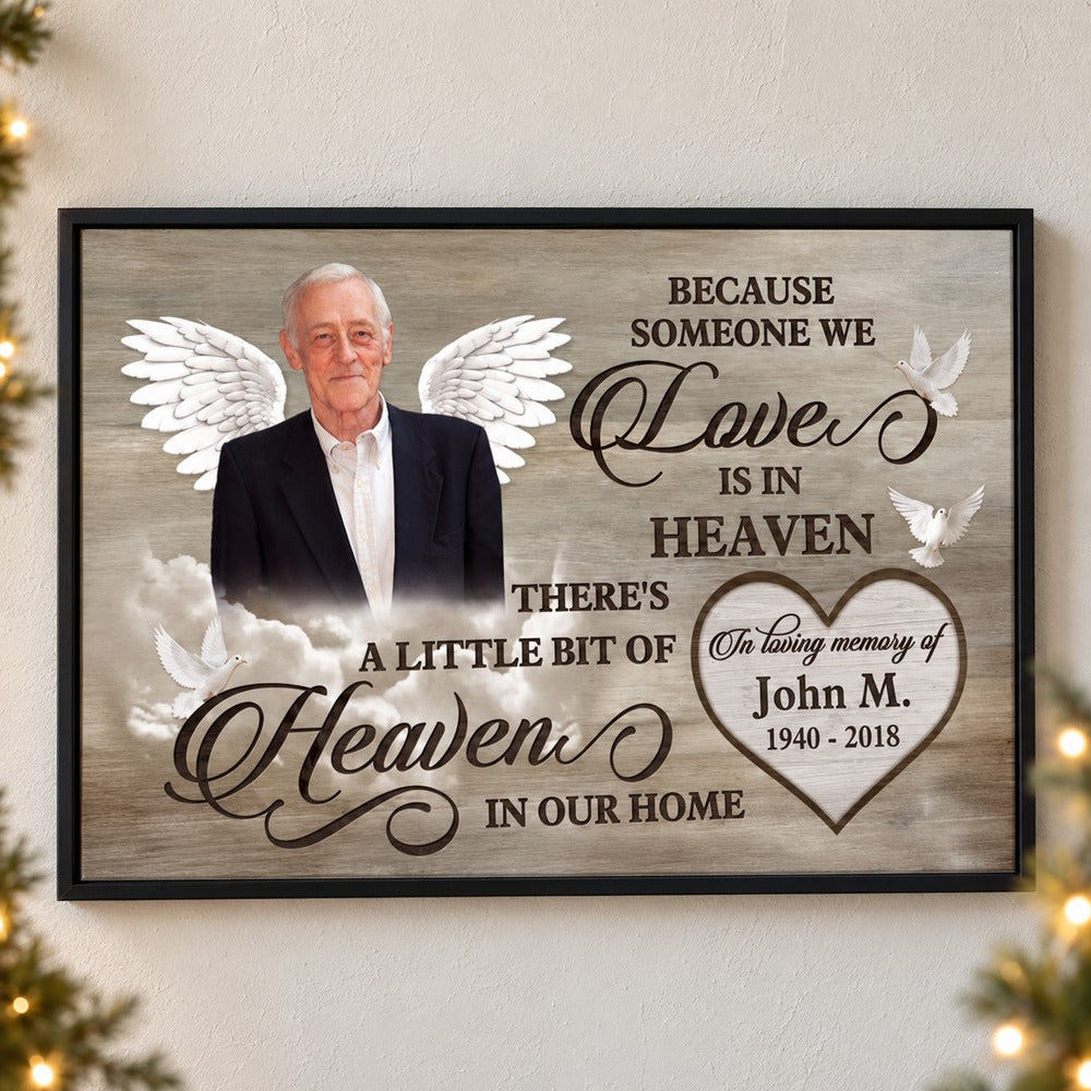 Personalized Love Is In Heaven memorial canvas print on a wall with soft holiday greenery and lights