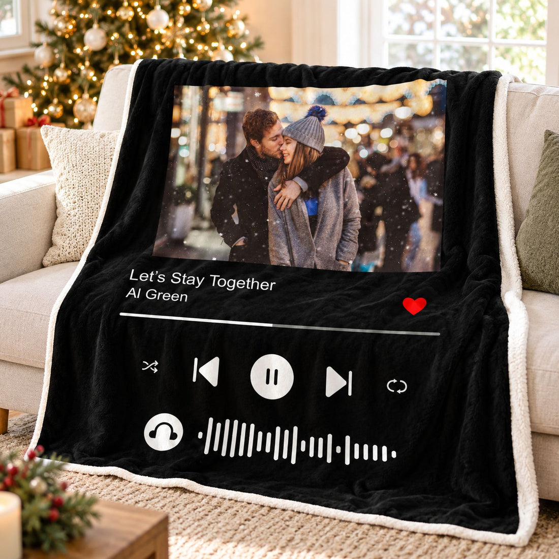 Custom song photo blanket for couples draped on a cozy sofa with holiday lights in background