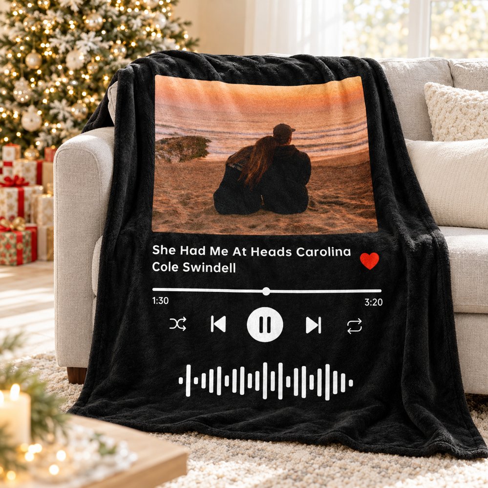 Custom wedding song photo blanket draped on a cozy sofa near a Christmas tree