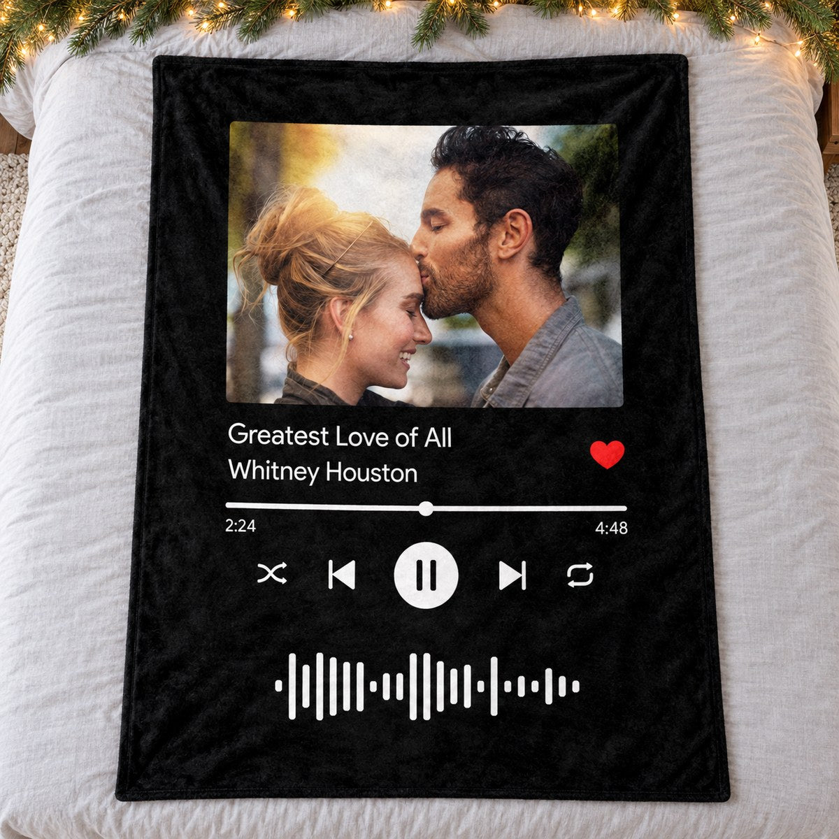 Personalized couple song photo fleece blanket spread flat on a cozy holiday bed with pine garland