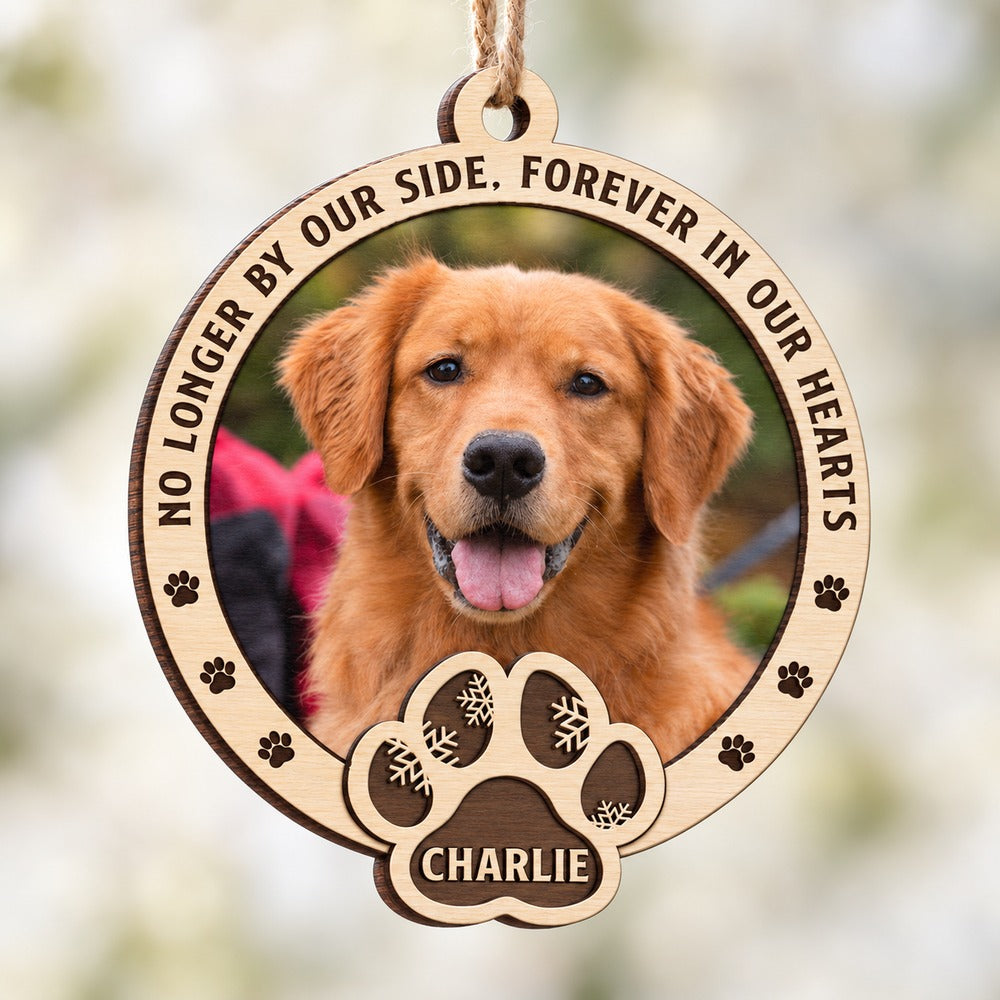 Close up detail of layered wood paw print cutout and engraving on pet memorial ornament