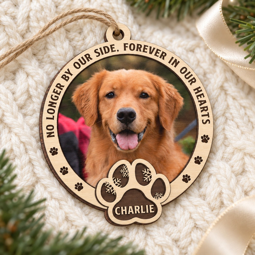 Custom photo dog memorial wood ornament lying flat on a cozy cream knit blanket
