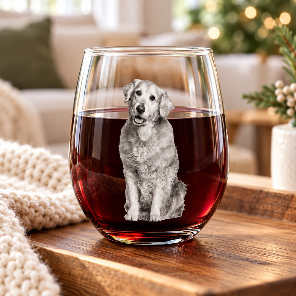 Custom pet photo stemless wine glass filled with red wine on a cozy wooden tray