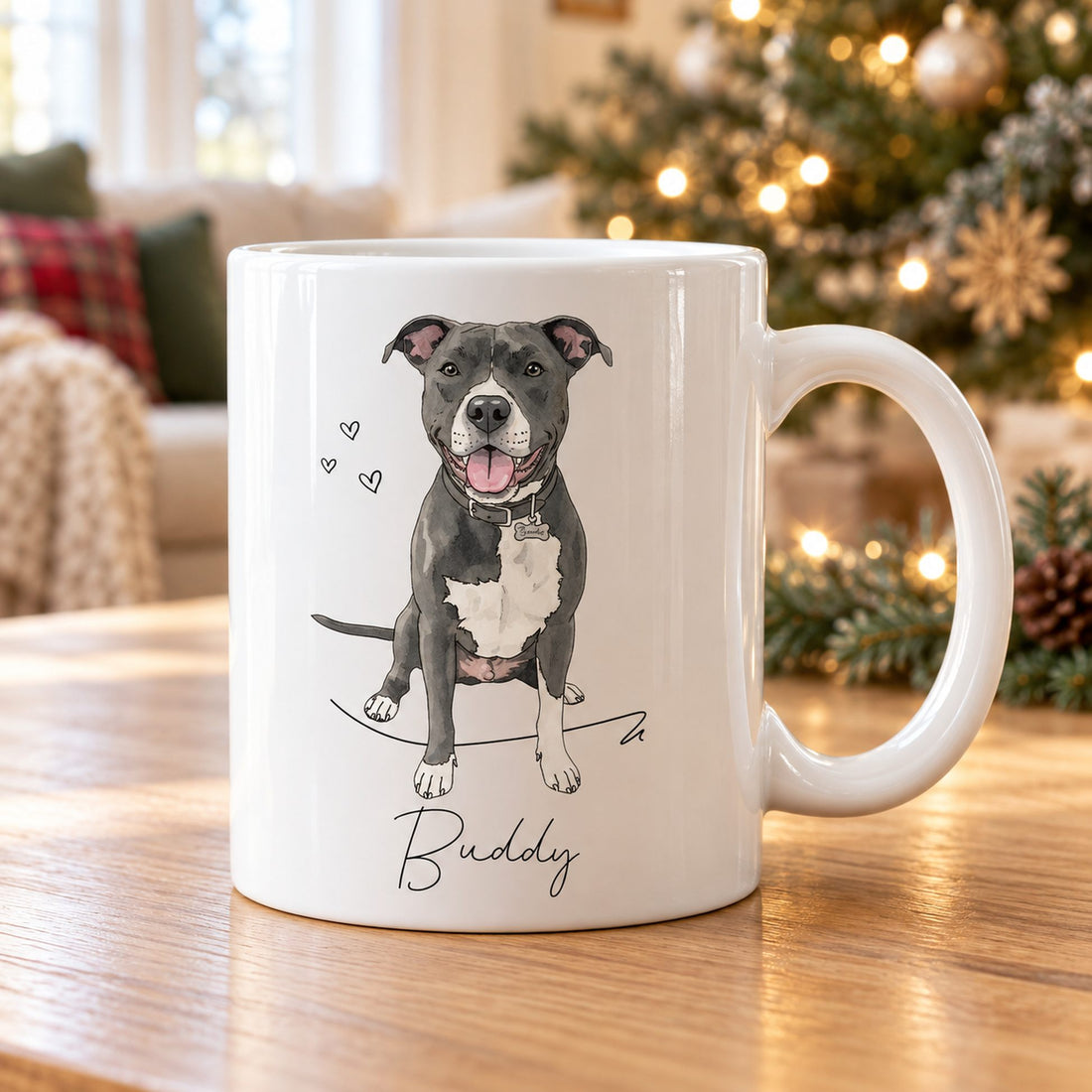 Custom watercolor pet portrait mug on a holiday coffee table with Christmas tree lights behind